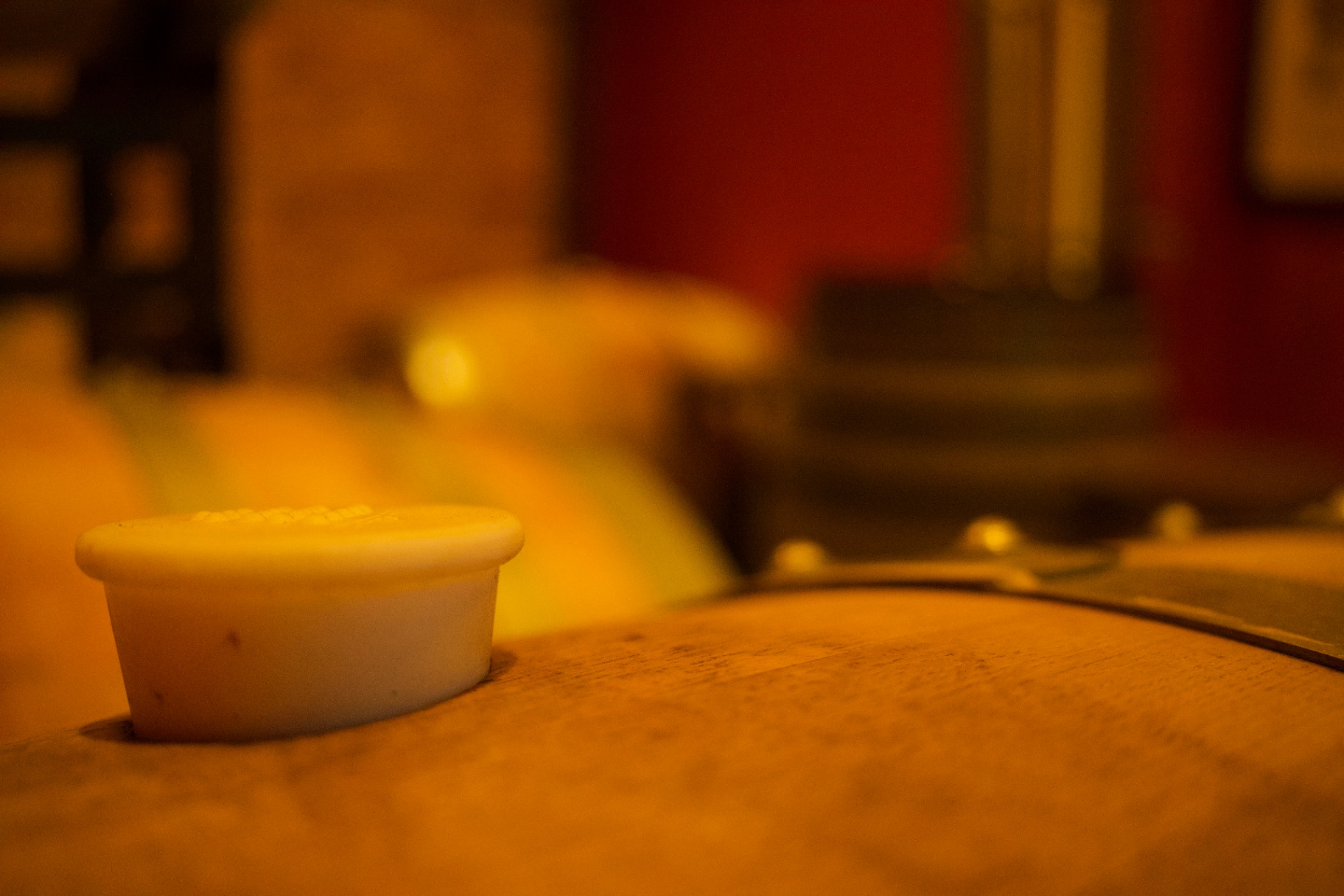 Warm gold-toned close-up of a barrel bung