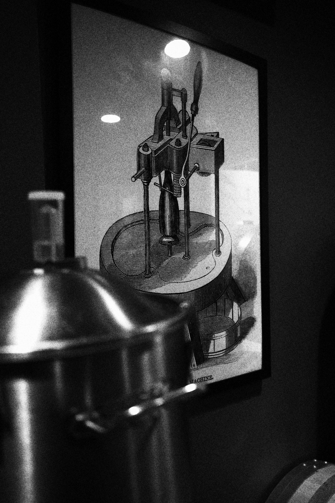 Framed vintage winemaking machinery illustration on the cellar wall